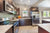 A kitchen with concealed cabinets and white quartz countertops
