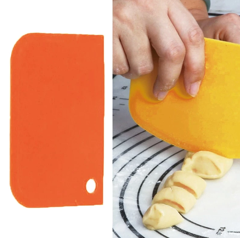 hand cutting a dough using a baking scraper 
