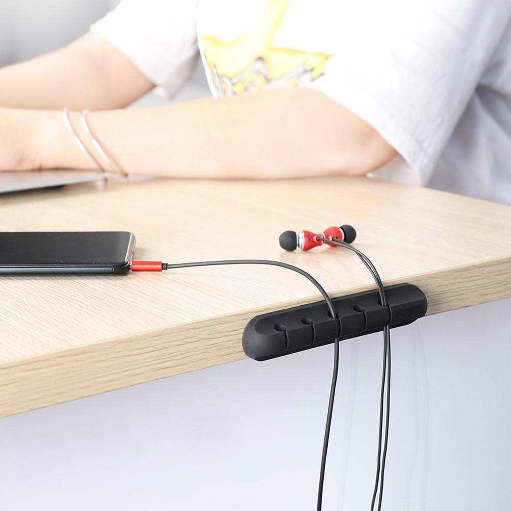 cable organizer attached on the desk edge with a phone