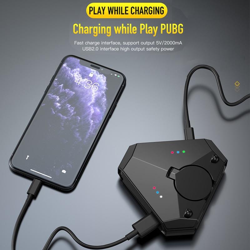 mobile phone charging and connected to a gaming converter through a USB cable 