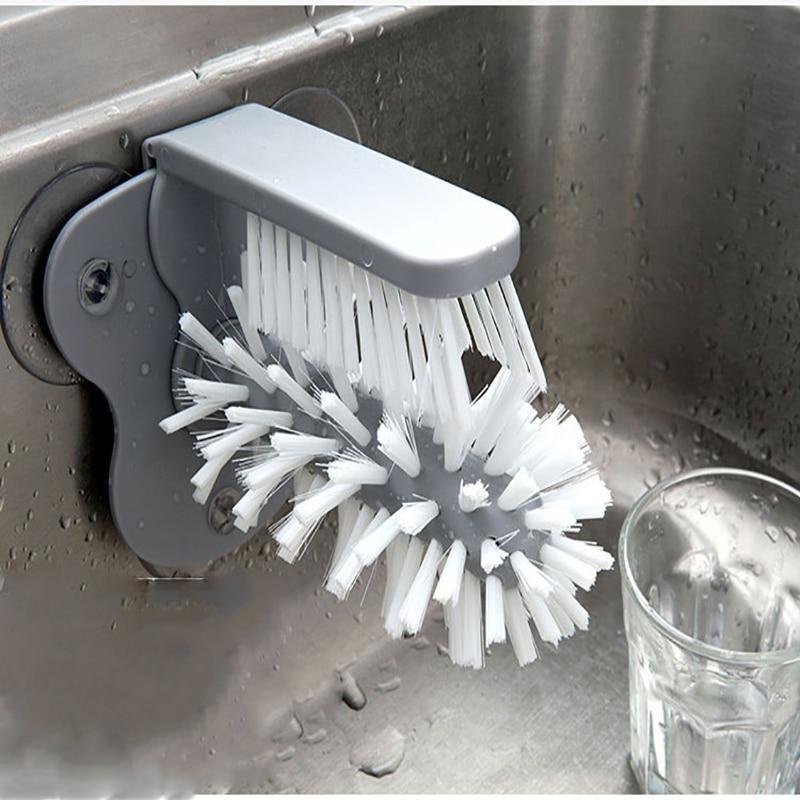 glass cleaning brush attached to the sink and a transparent glass