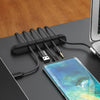 silicone cable organizer on desk with charging mobile phone