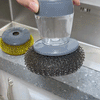 a lady cleaning kitchen wares and sink using the soap dispensing palm brush