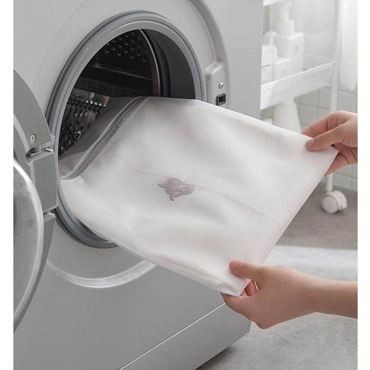hand putting a mesh laundry bag into the washing machine
