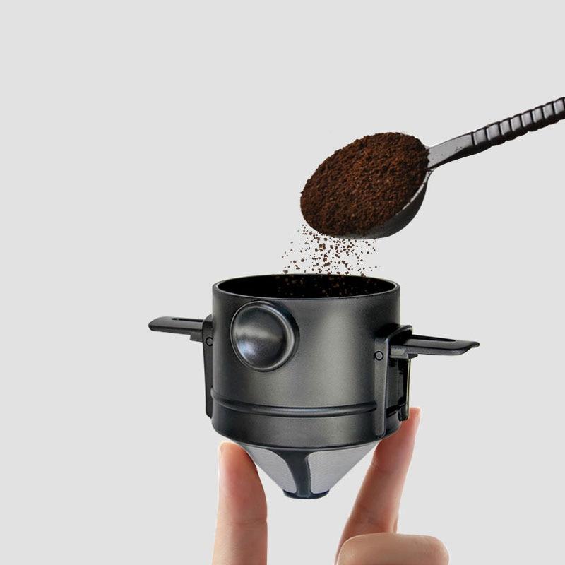 hand holding a coffee filter and spoon with ground coffee