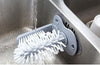 glass cleaning brush attached to the kitchen sink