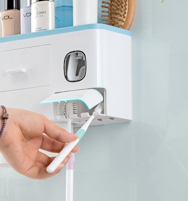 hand putting a toothbrush on a toothbrush holder
