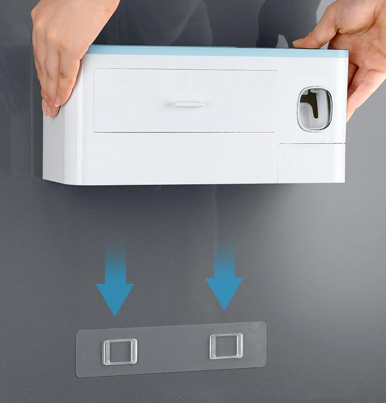 hand holding a wall organizer and arrows pointing on the organizer adhesive